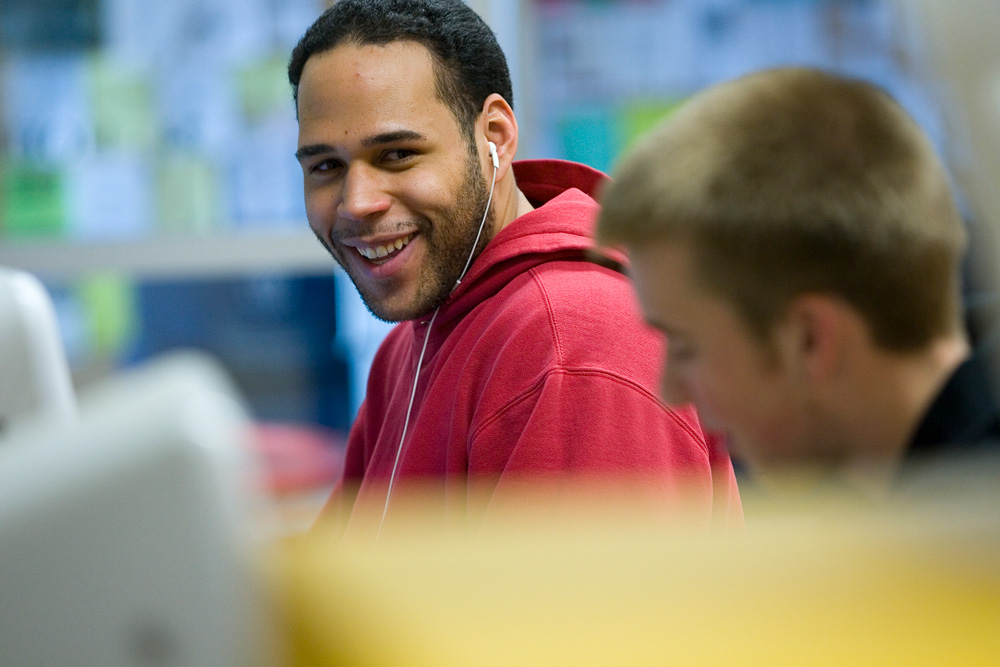 070313c327 Male student smiling while at a computer